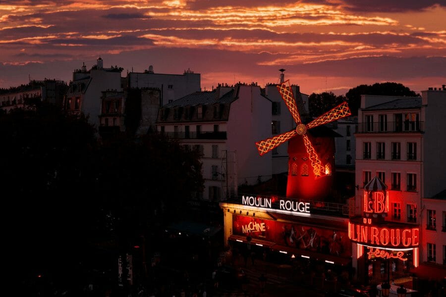The facade of the Moulin Rouge with its iconic windmill