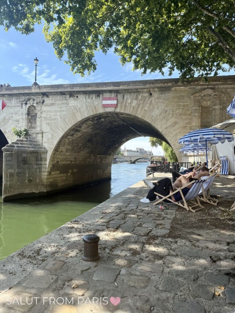Deckchairs along the Seine under the shade of trees during Paris Plages in summer