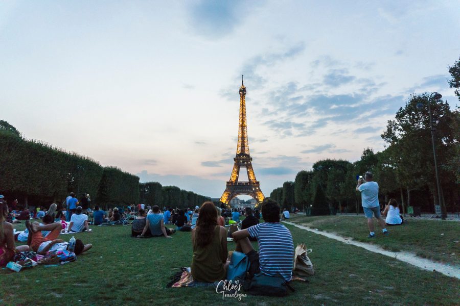 Paris for Couples: Couple sits in front of the Eiffel Tower