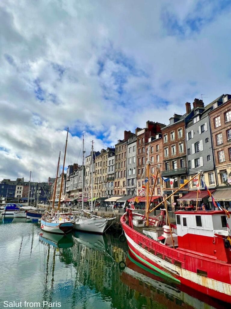 Harbour of Honfleur with ships and sail boats. Shots and houses in the backdrop