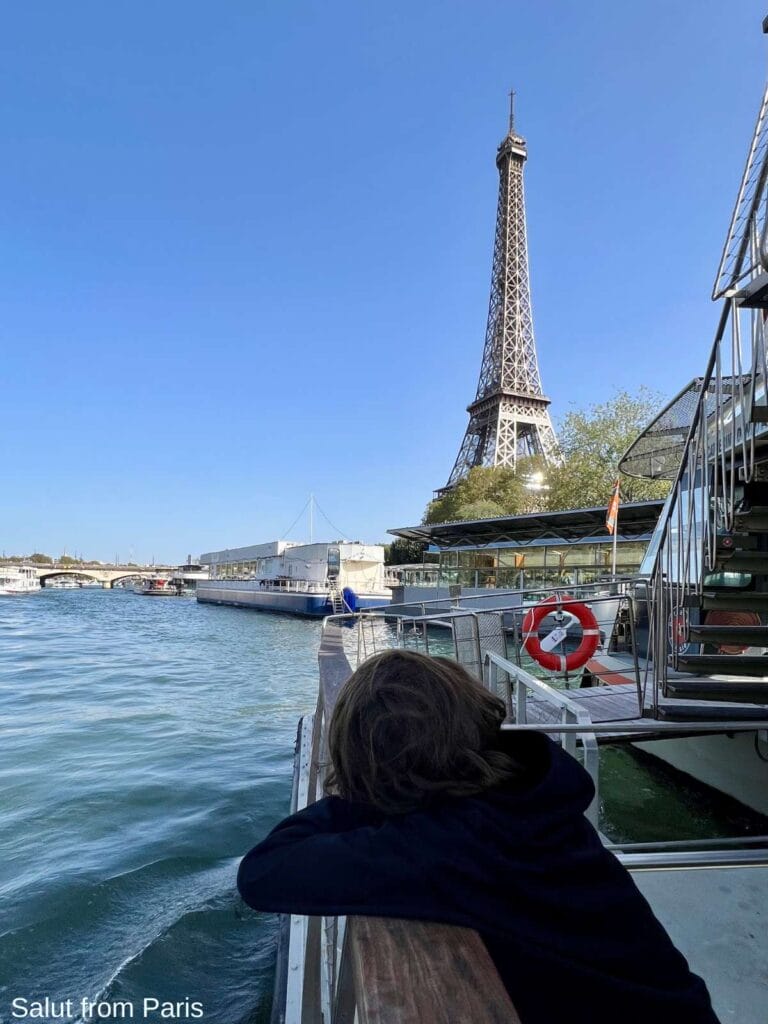 Eiffel Tower and Seine Cruise, with boy looking at the tower