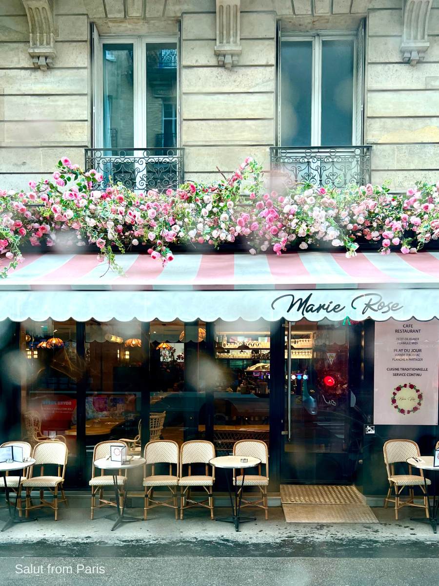 Paris on a rainy day, storefront of a restaurant with rose decorations