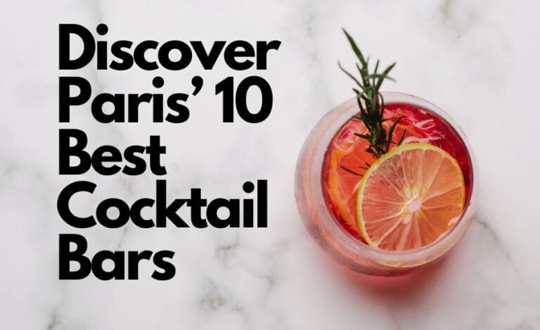 The image shows a promotional graphic with the text "Discover Paris' 8 Best Cocktail Bars" in bold black letters on the left side. On the right side, there is a top-down view of a vibrant cocktail served in a clear glass. The drink is garnished with a slice of citrus fruit, possibly a combination of lemon and lime, and a sprig of rosemary. The background is a white marble surface, giving the image a clean and elegant look. The composition is stylish and inviting, perfectly suited to draw attention to a guide on top cocktail bars in Paris.