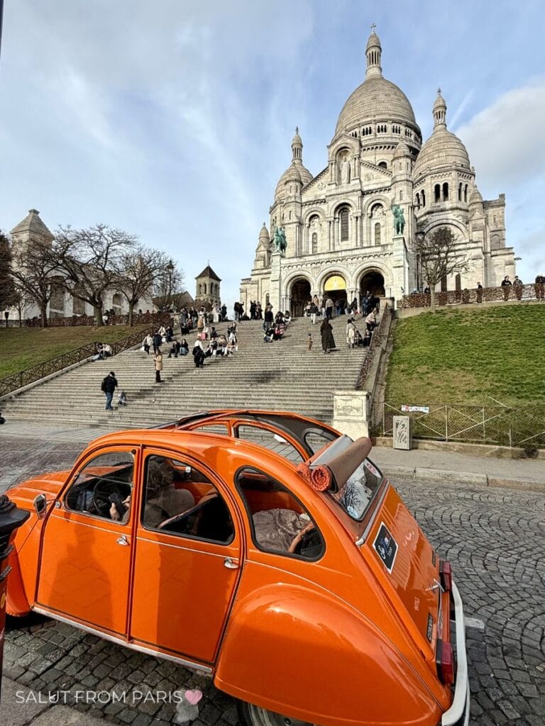 Vintage CV2 in front of Sacre Coeur in Montmartre. Blue skies and only a few people are visiting the stairs in front of Sacre Coeur