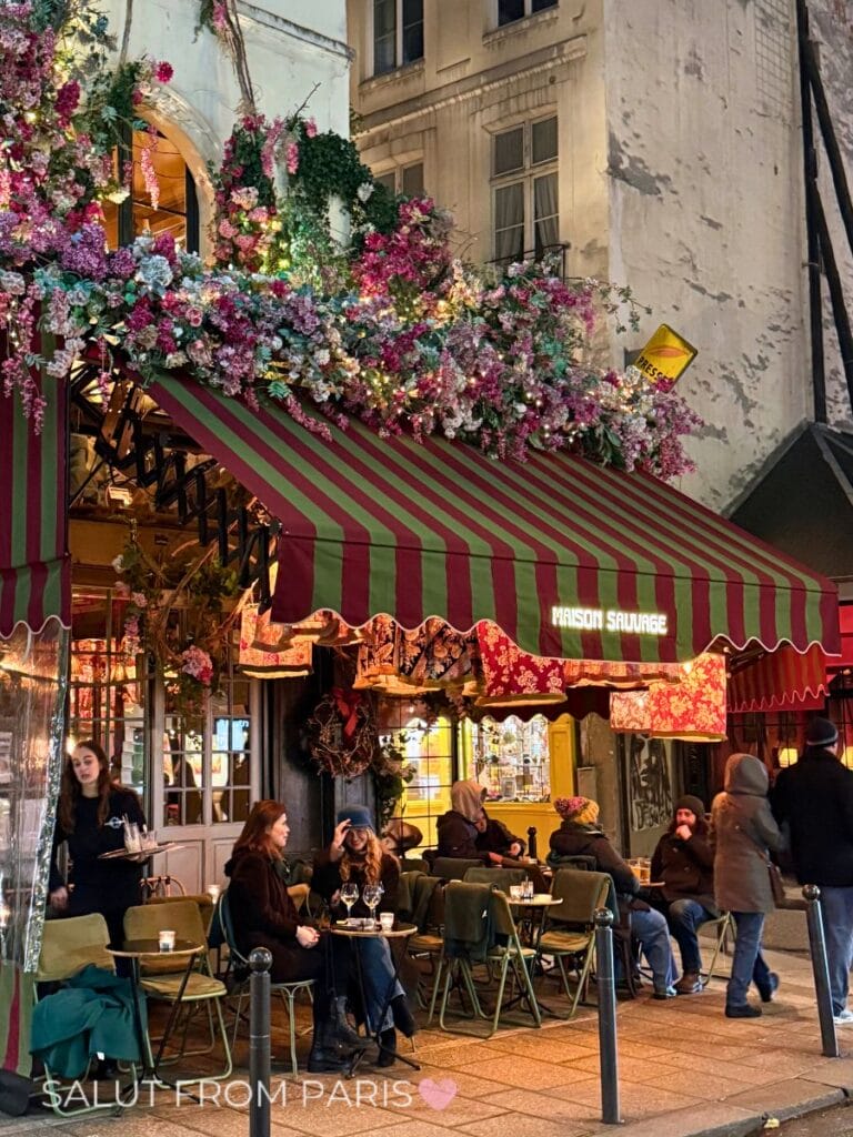 Maison Sauvage on Rue de Buci - with flowers along the ceiling and house facades
