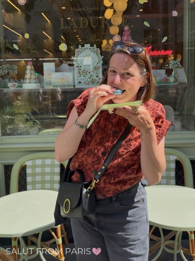Me taking a bite of a blue macaron outside the Ladurée café during the walking tour in the Marais. Eating is certainly on the best things you can do in Le Marais