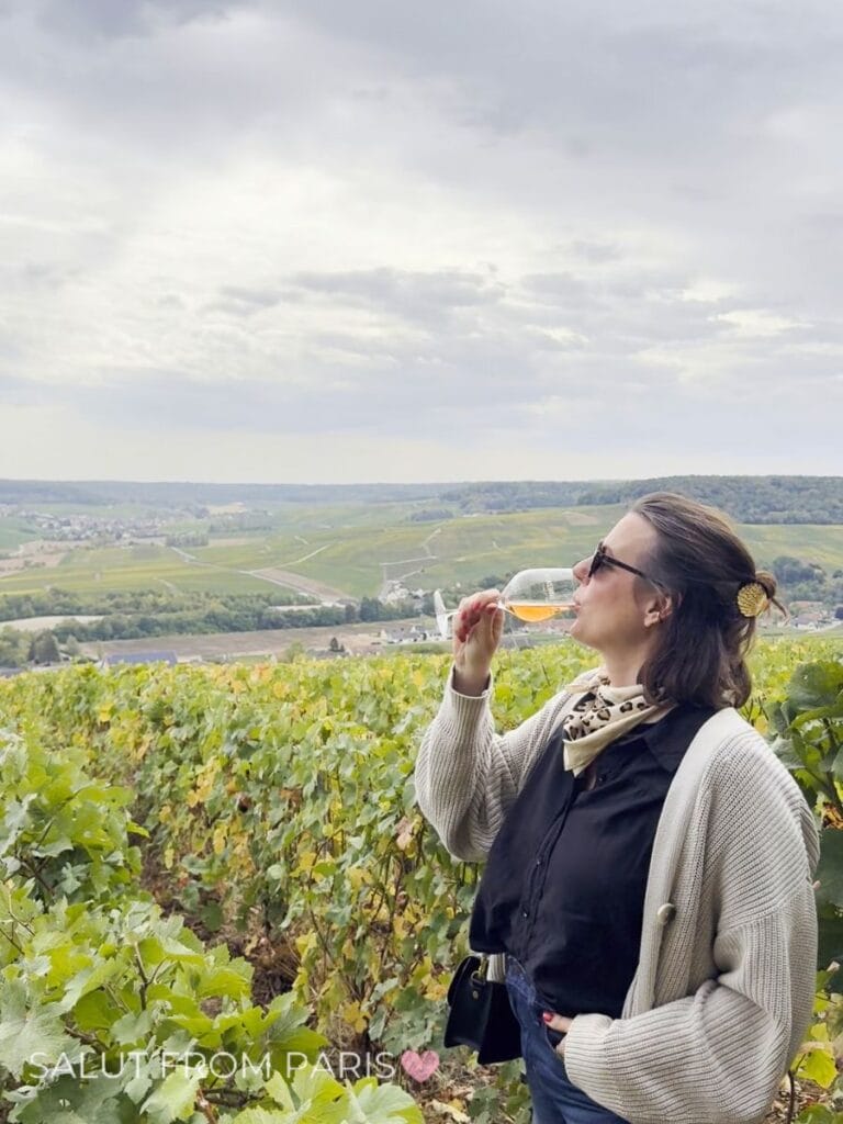 Me in the vineyards of CHampagne with a glass of Rosé in my hand