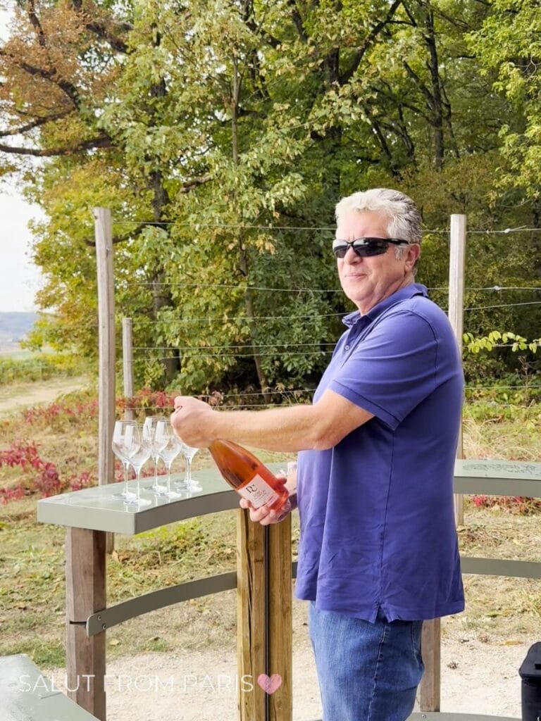 Tour guide opens bottle of Champagne